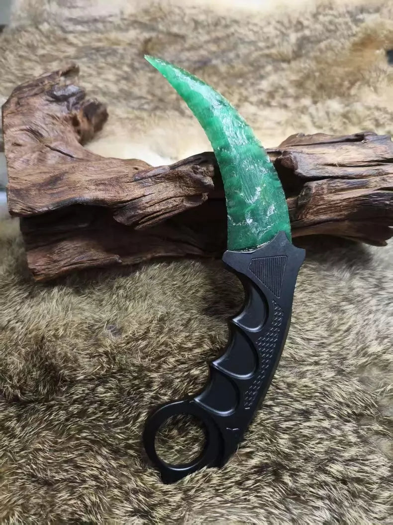 Hand-crafted stone-style karambit with deep green cat's-eye stone and metal handle; menacing karambit; Doppler Emerald karambit.