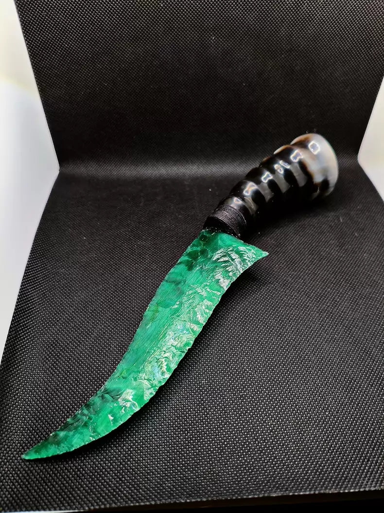 Flaked stone knives; deep green cat's-eye stone knife; flame-shaped stone knife; obsidian knife; obsidian "dragon-glass" blade.