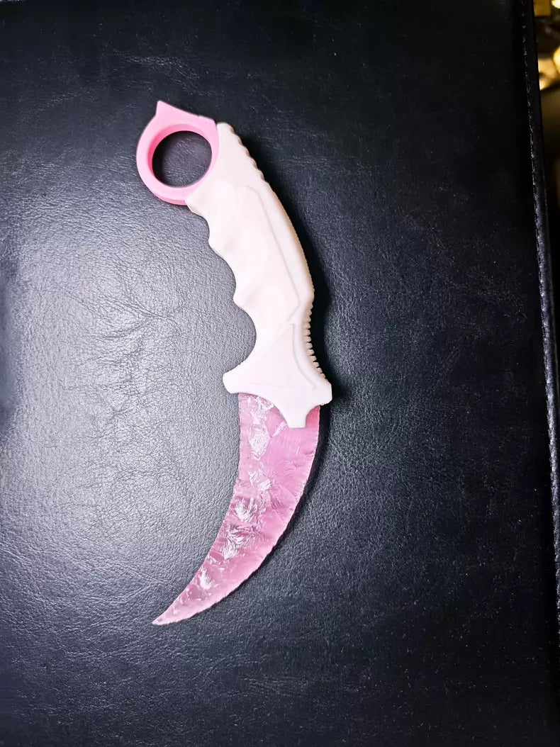 Knapped stone knife; karambit; pink cat's-eye stone karambit.