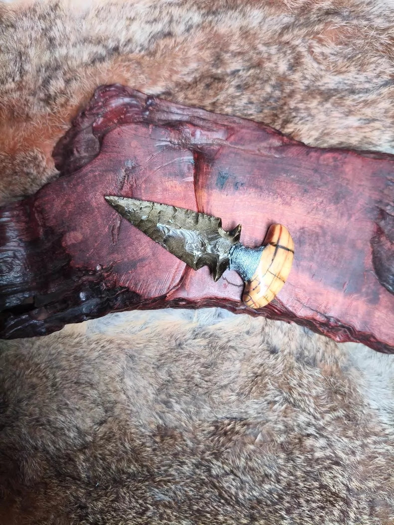Knapped gold-sheen obsidian knife with a stabilized mammoth tusk handle.