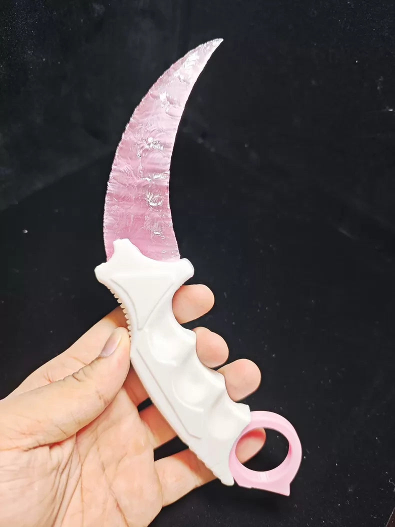 Knapped stone knife; karambit; pink cat's-eye stone karambit.