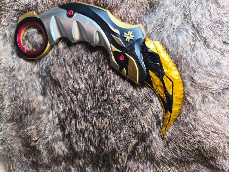 Hand-crafted stone tool replica: Valorant Champions 2021 Karambit (Mercy); obsidian-style hand-crafted stone base with a gold finish.