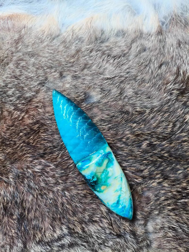 Hand-knapped stone blade with a stabilized mammoth ivory handle and blue cat's-eye stone inlay; a tactile art piece featuring pressure-flaking craftsmanship.