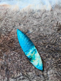 Hand-knapped stone blade with a stabilized mammoth ivory handle and blue cat's-eye stone inlay; a tactile art piece featuring pressure-flaking craftsmanship.