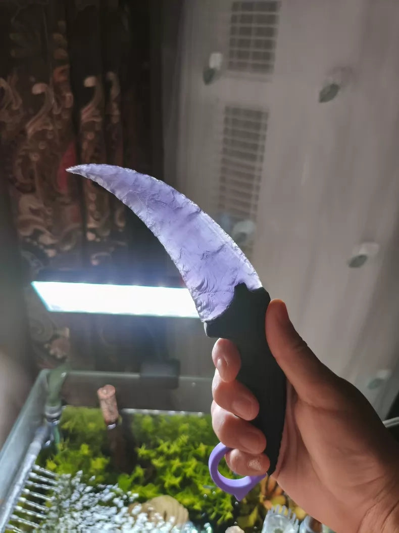 Knapped stone knife; pale lavender cat's-eye opal karambit.