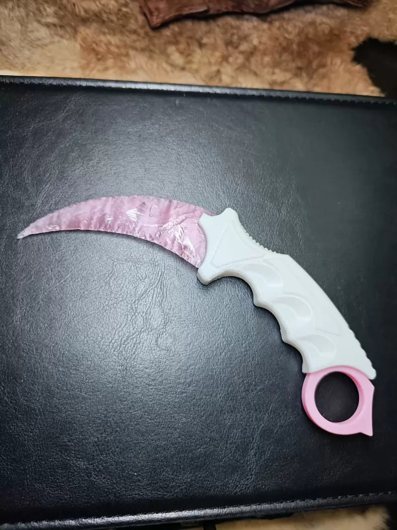 Knapped stone knife; karambit; pink cat's-eye stone karambit.