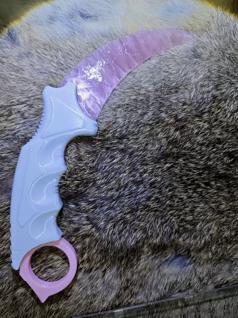 Knapped stone knife; karambit; pink cat's-eye stone karambit.