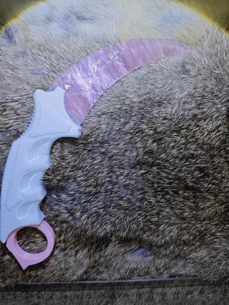 Knapped stone knife; karambit; pink cat's-eye stone karambit.