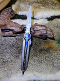 Chipped stone tool; Polaris-style metal handle; silvery-white cat's-eye stone Polaris motif.