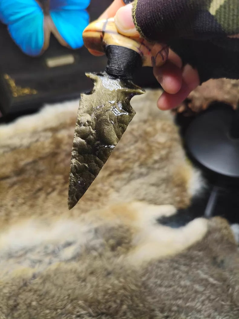 Knapped gold-sheen obsidian knife with a stabilized mammoth tusk handle.