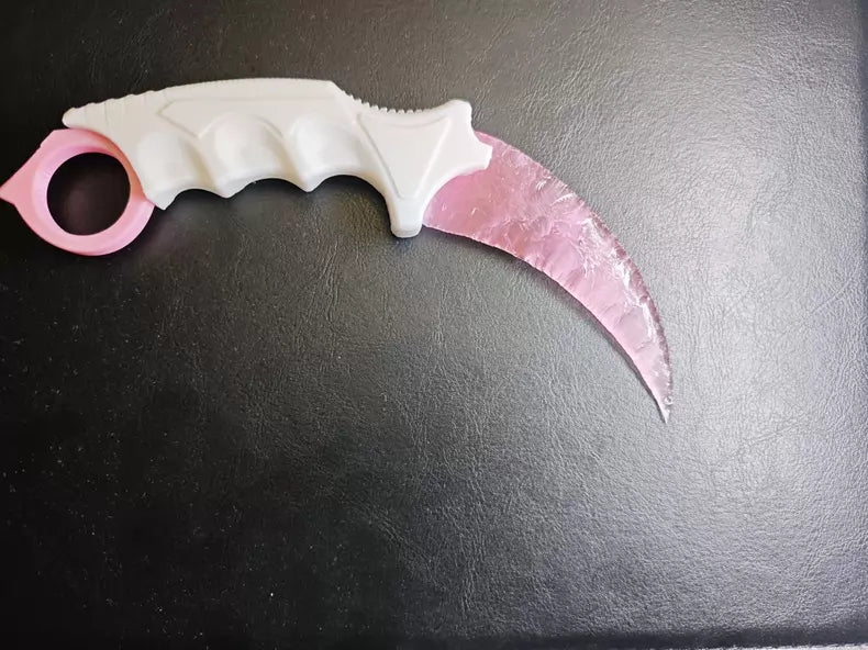 Knapped stone knife; karambit; pink cat's-eye stone karambit.