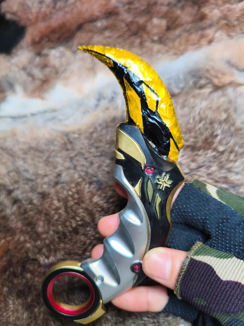 Hand-crafted stone tool replica: Valorant Champions 2021 Karambit (Mercy); obsidian-style hand-crafted stone base with a gold finish.