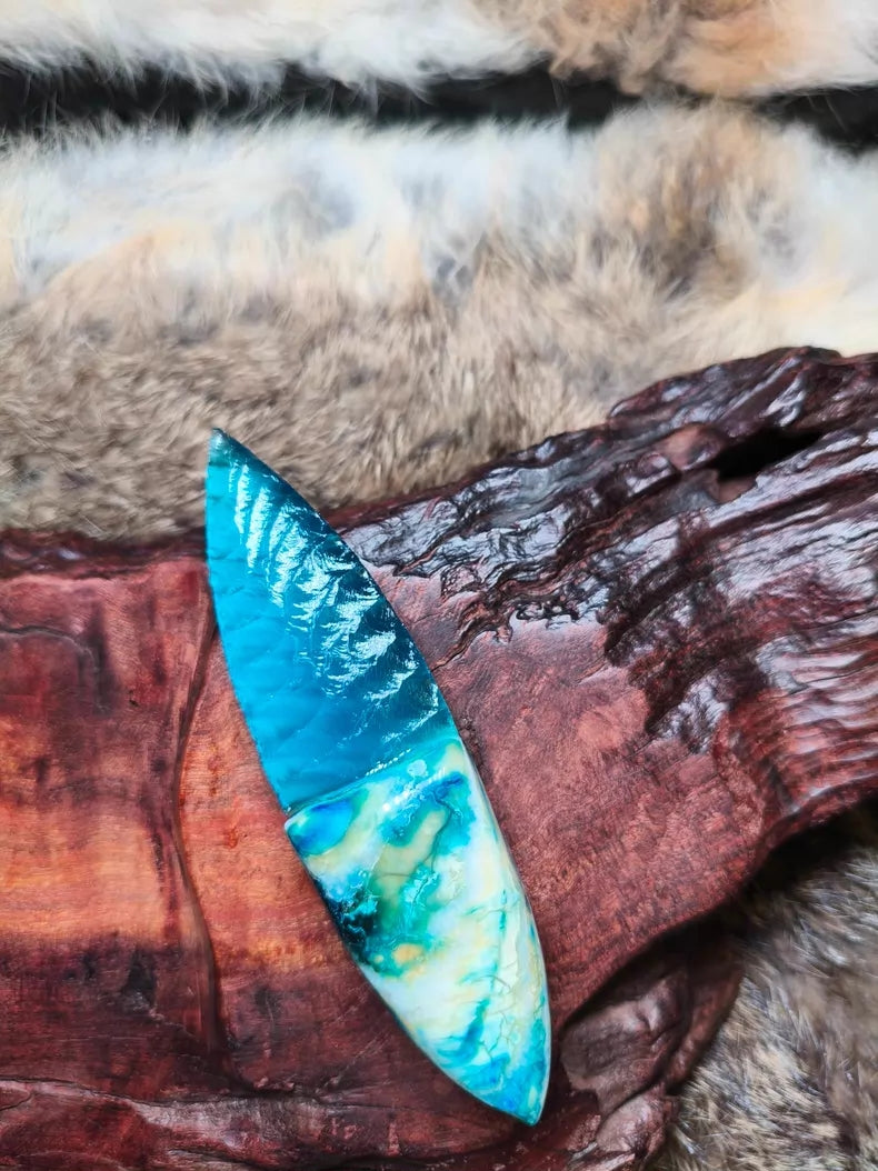 Hand-knapped stone blade with a stabilized mammoth ivory handle and blue cat's-eye stone inlay; a tactile art piece featuring pressure-flaking craftsmanship.