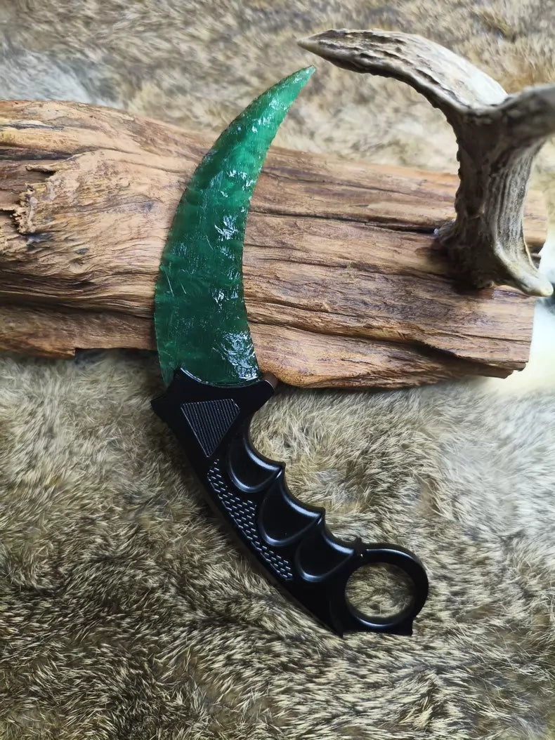 Hand-crafted stone-style karambit with deep green cat's-eye stone and metal handle; menacing karambit; Doppler Emerald karambit.