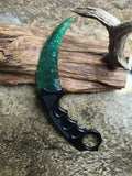 Hand-crafted stone-style karambit with deep green cat's-eye stone and metal handle; menacing karambit; Doppler Emerald karambit.