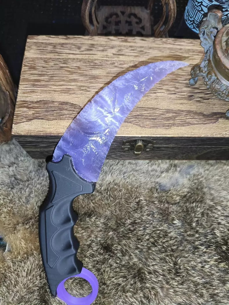 Knapped stone knife; pale lavender cat's-eye opal karambit.