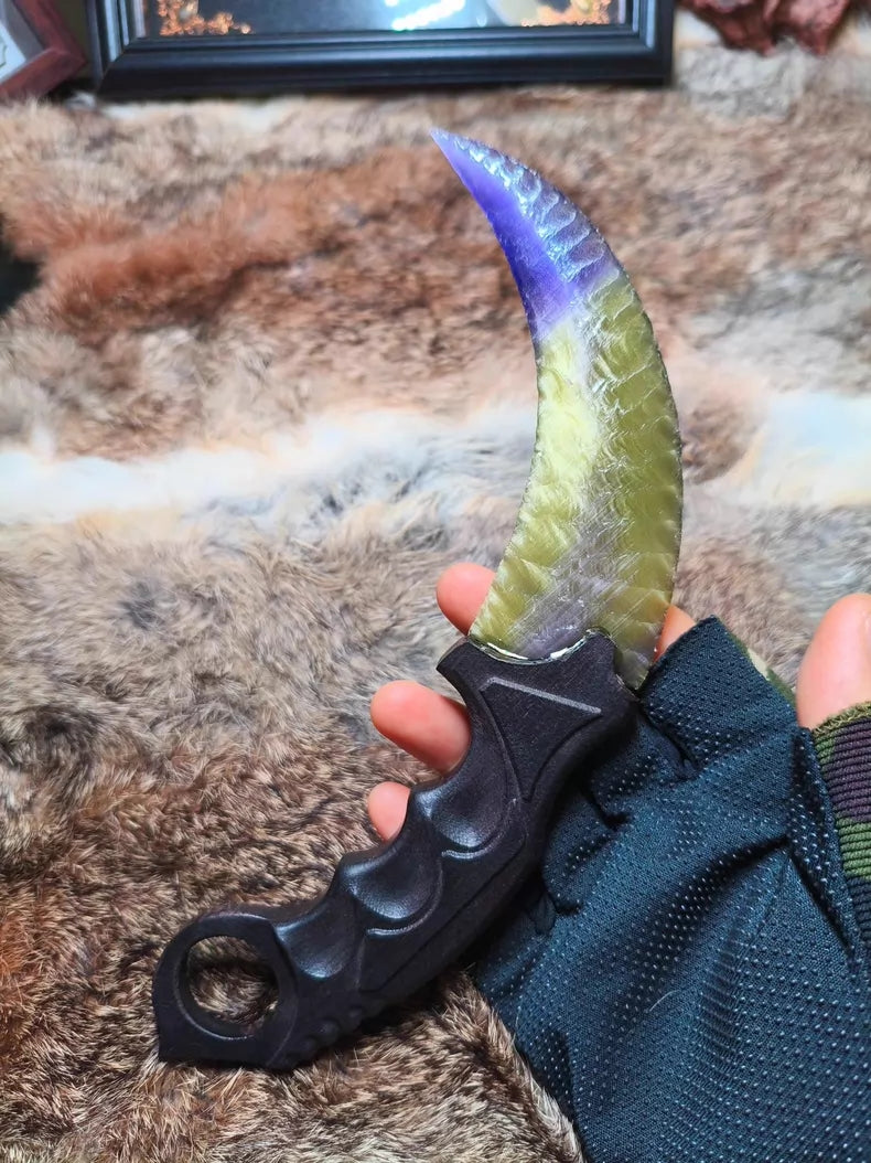 Flaked stone blade featuring the profile of a CS:GO Karambit, crafted with a colorful cat's-eye effect and pressure-flaking technique.