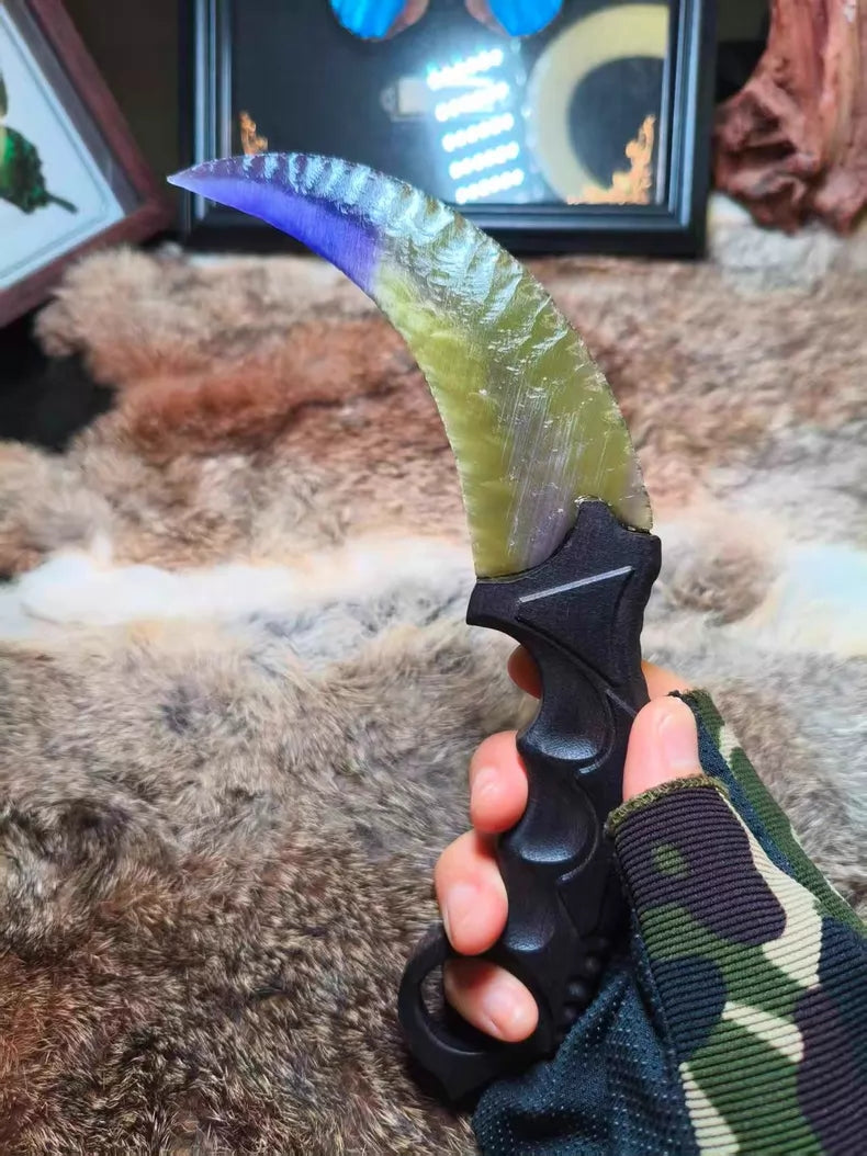 Flaked stone blade featuring the profile of a CS:GO Karambit, crafted with a colorful cat's-eye effect and pressure-flaking technique.