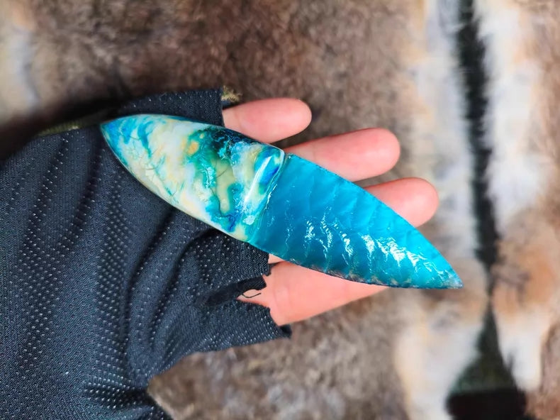 Hand-knapped stone blade with a stabilized mammoth ivory handle and blue cat's-eye stone inlay; a tactile art piece featuring pressure-flaking craftsmanship.