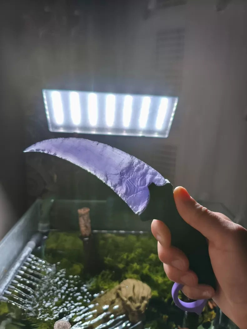 Knapped stone knife; pale lavender cat's-eye opal karambit.