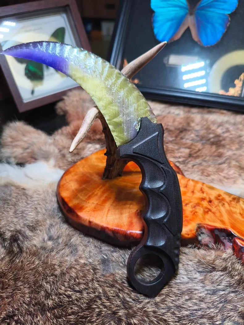 Flaked stone blade featuring the profile of a CS:GO Karambit, crafted with a colorful cat's-eye effect and pressure-flaking technique.