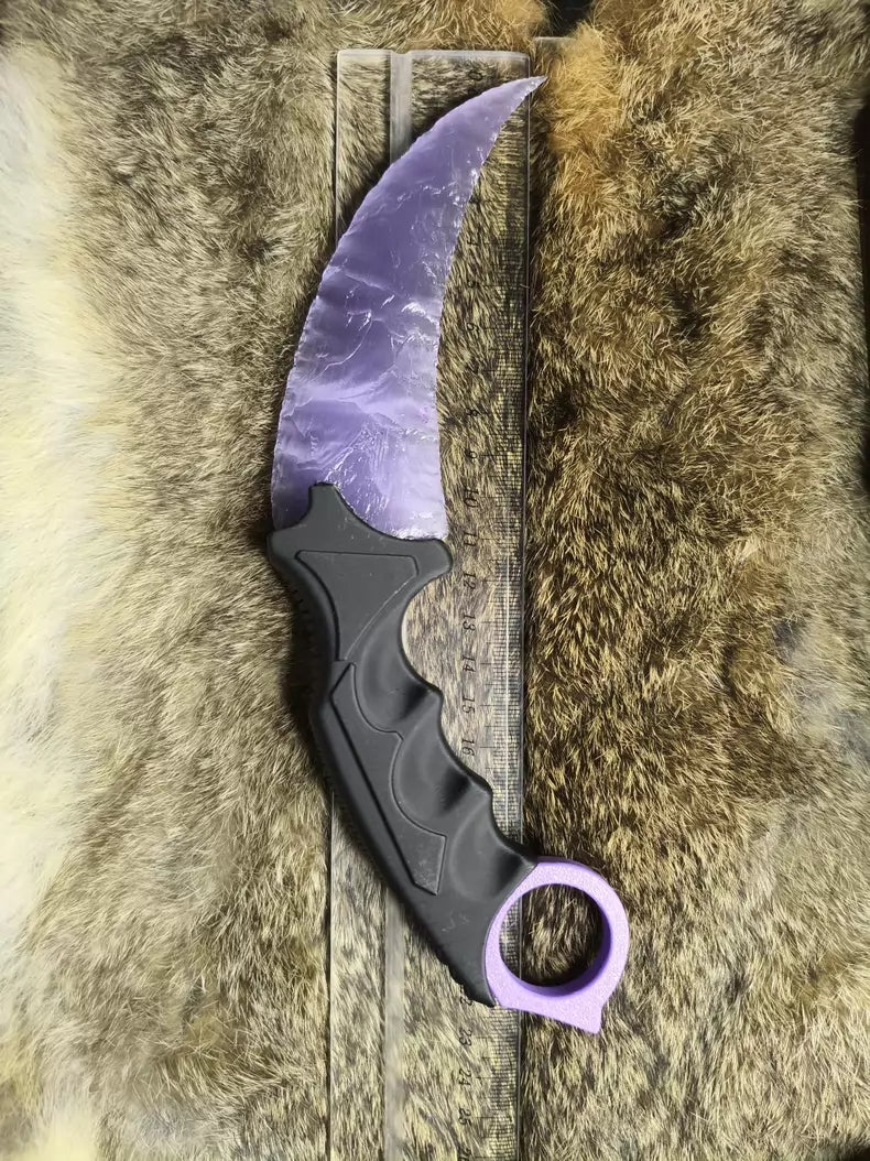 Knapped stone knife; pale lavender cat's-eye opal karambit.