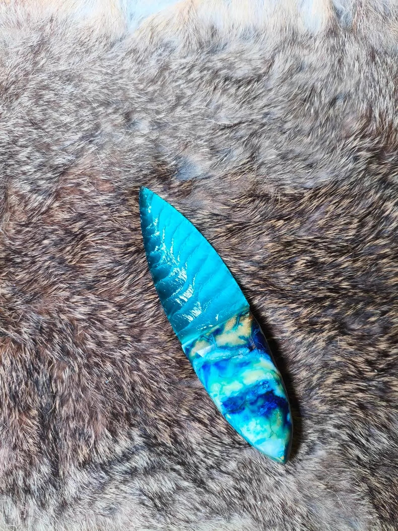 Hand-knapped stone blade with a stabilized mammoth ivory handle and blue cat's-eye stone inlay; a tactile art piece featuring pressure-flaking craftsmanship.