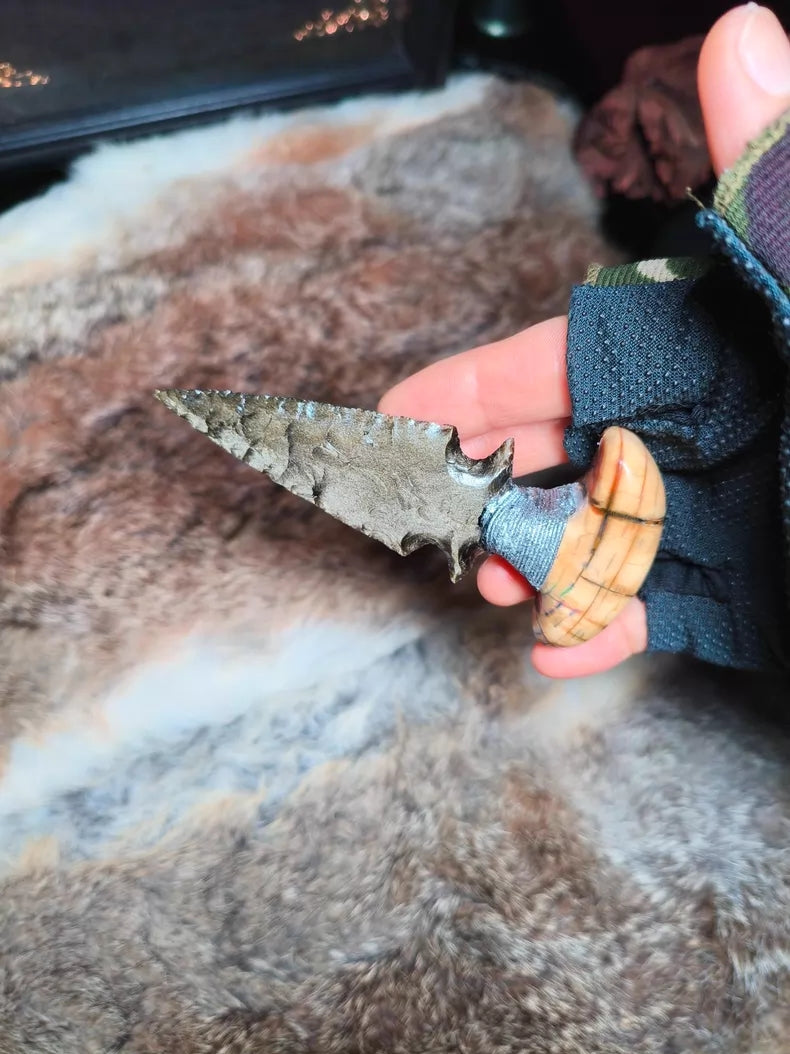 Knapped gold-sheen obsidian knife with a stabilized mammoth tusk handle.