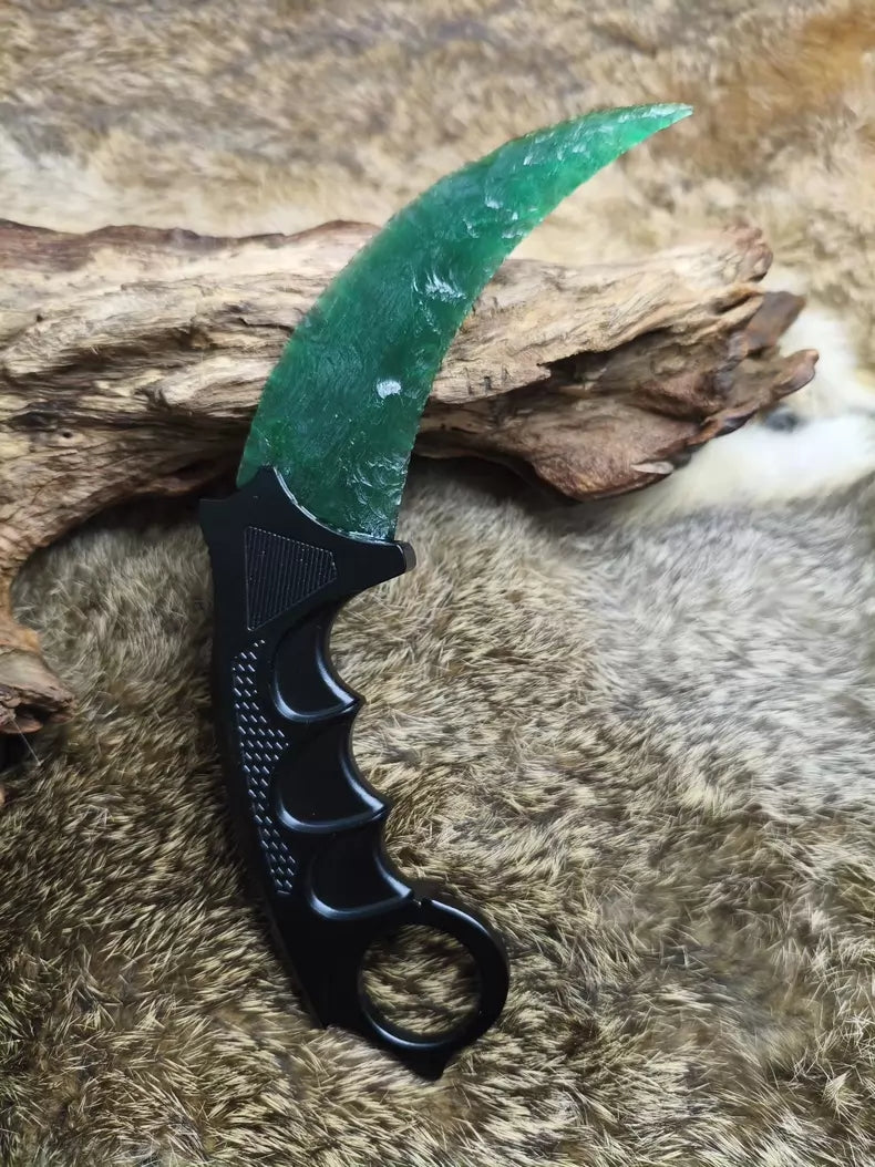 Hand-crafted stone-style karambit with deep green cat's-eye stone and metal handle; menacing karambit; Doppler Emerald karambit.