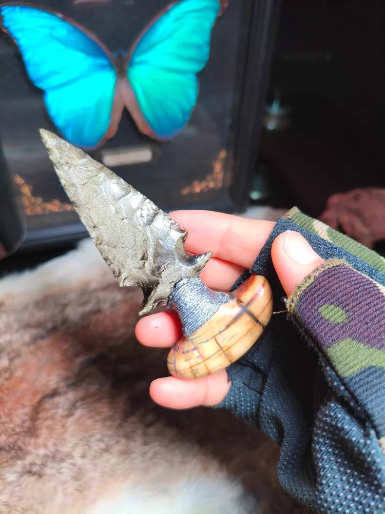 Knapped gold-sheen obsidian knife with a stabilized mammoth tusk handle.