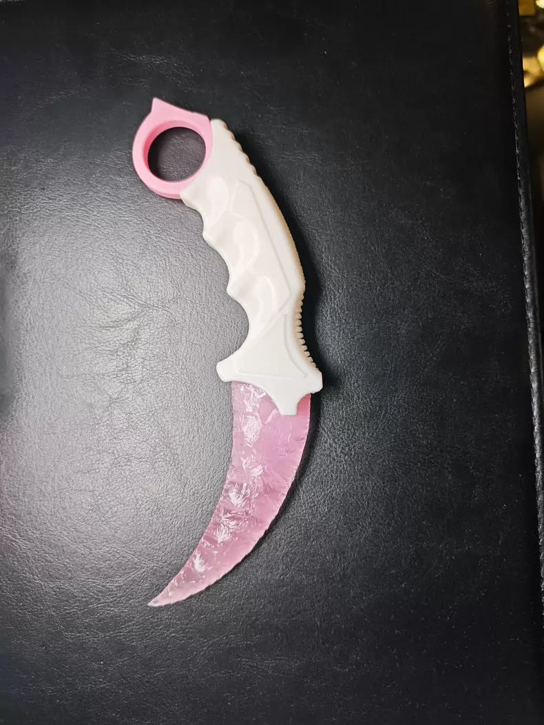 Knapped stone knife; karambit; pink cat's-eye stone karambit.