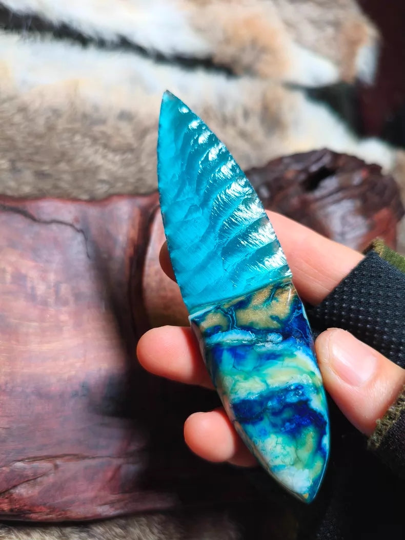 Hand-knapped stone blade with a stabilized mammoth ivory handle and blue cat's-eye stone inlay; a tactile art piece featuring pressure-flaking craftsmanship.