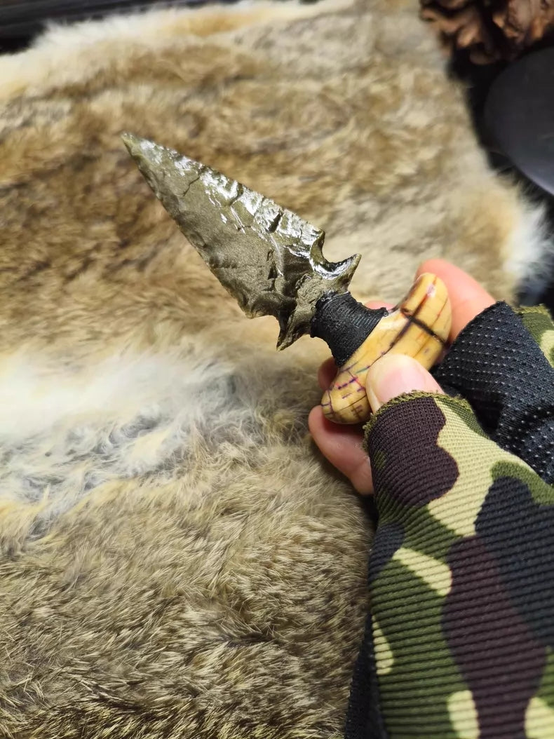 Knapped gold-sheen obsidian knife with a stabilized mammoth tusk handle.